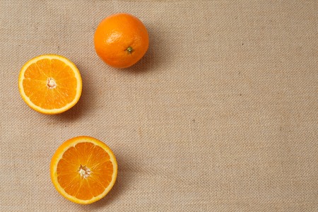 Fresh Orange lying on a sackcloth surfaceの写真素材