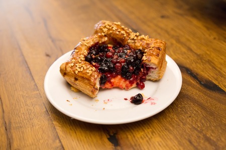 Luscious cake with fresh berries lying on a white plateの写真素材