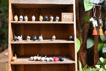 Wooden shelf with ceramic figurines of birds in the garden.の写真素材