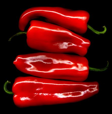 red sweet peppers paprika on black background
