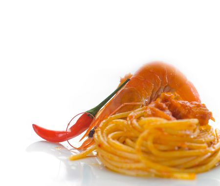 italian spaghetti pasta and fresh spicy shrimps sauce over whiteの写真素材