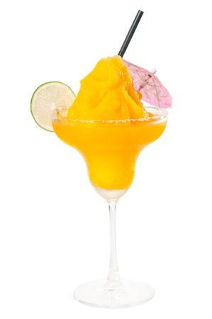 frozen mango margarita daiquiri with lime black straw and pink umbrella isolated on white backgroundの写真素材