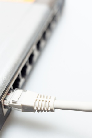network hub switch with lan cable connected over whiteの写真素材
