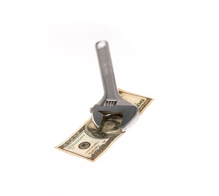 wrench tool fixing dollar bill isolated on white background  closeupの写真素材