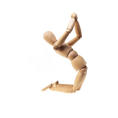 wood mannekin on praying position isolated over whiteの写真素材