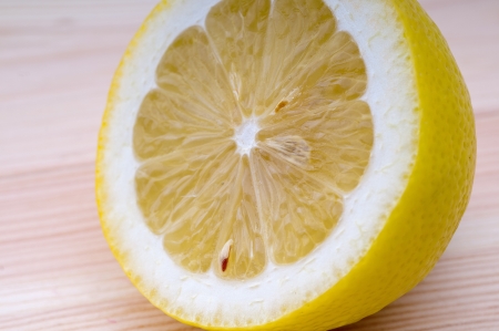 fresh ripe lemon cutted in half closedup over wood tableの写真素材