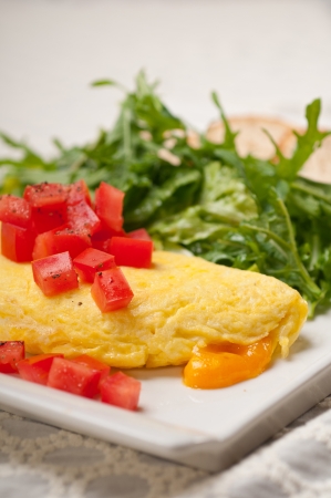 home made omelette with cheese tomato and rucola rocket salad arugolaの写真素材