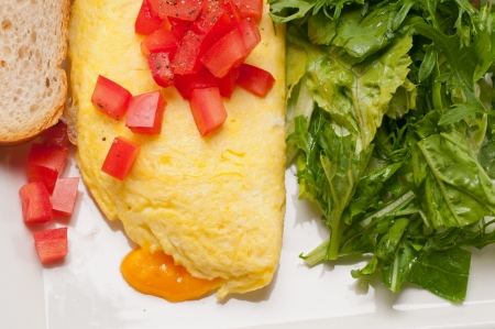 home made omelette with cheese tomato and rucola rocket salad arugolaの写真素材