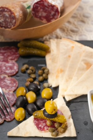 fresh cold cut platter with pita bread and pickles antipastiの写真素材