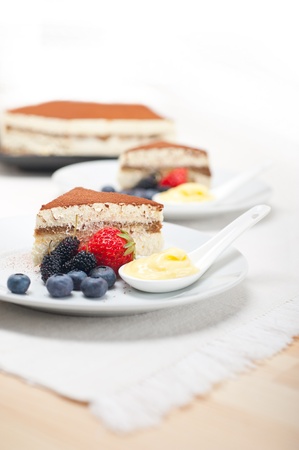 classic Italian tiramisu dessert with berries and custartd pastry cream on side の写真素材