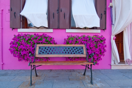 bench in front of traditional colorful houses の写真素材