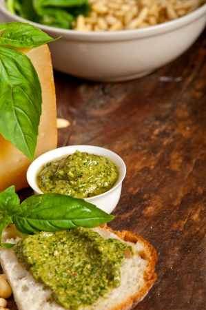 Italian basil pesto bruschetta ingredients over old wood macroの写真素材