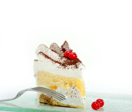 fresh ribes and whipped cream dessert cake slice with cocoa powder on topの写真素材