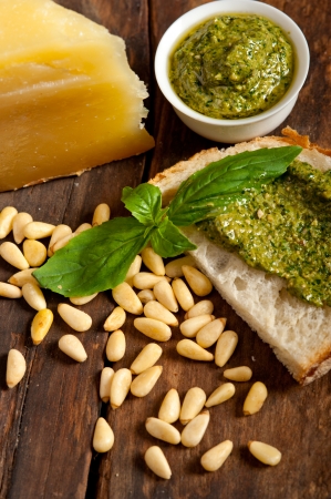 Italian basil pesto bruschetta ingredients over old wood macroの写真素材