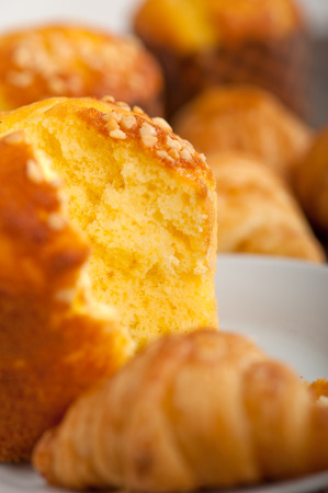 fresh baked muffin  and croissant mignon on old wood tableの写真素材