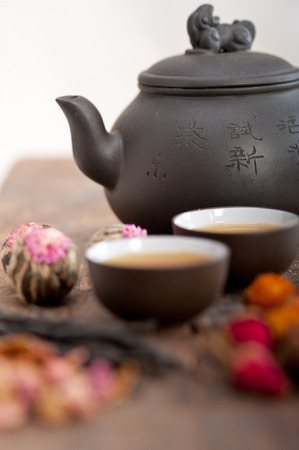 Chinese style herbal floral tea over wood table with raw ingredientsの写真素材