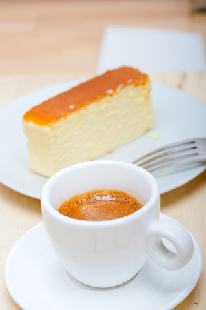 italian espresso coffee and cheese cake over white wood tableの写真素材