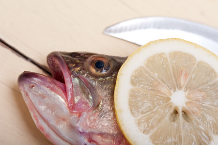 fresh whole raw fish on a wooden table ready to cook