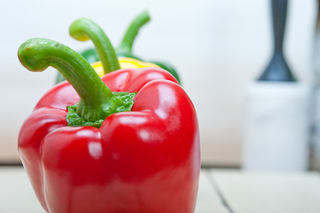 three fresh bell peppers over old wood tableの写真素材