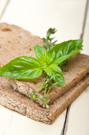 rustic Italian bread basil and thyme simple snack on white wood tableの写真素材