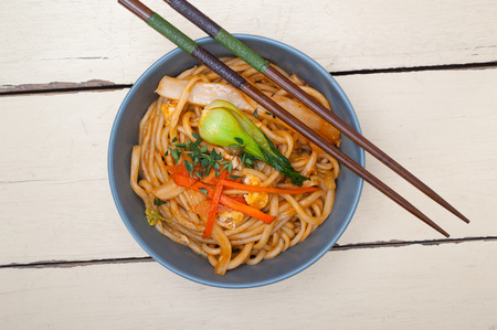 hand pulled stretched Chinese ramen noodles on a bowl with chopstick