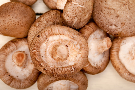fresh shiitake mushrooms on a rustic wood tableの写真素材