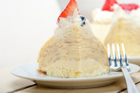 crepe pancake cake with whipped cream and strawberry on top