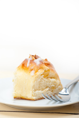 fresh home baked sweet bread donut cake with almonds and icing sugar on topの写真素材