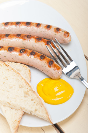traditional fresh German wurstel sausages grilled with yellow mustardの写真素材