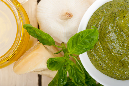 Italian traditional basil pesto sauce ingredients on a rustic tableの写真素材