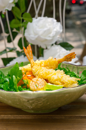 Fresh deep fried Japanese tempura shrimps with salad and sea urchinの写真素材