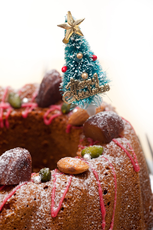 Christmas cake donut with tree as festive decoration on top over white backgroundの写真素材