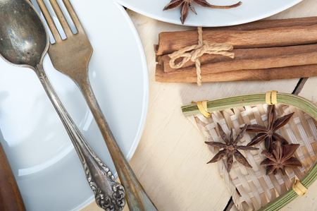 rustic table set  and spices knife spoon fork view from topの写真素材