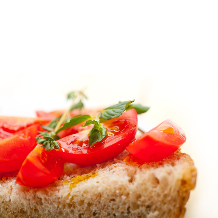 Italian tomato bruschetta with thyme and mint leavesの写真素材