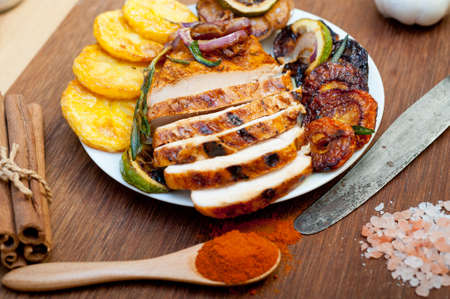 roasted grilled BBQ chicken breast with herbs and spices rustic style