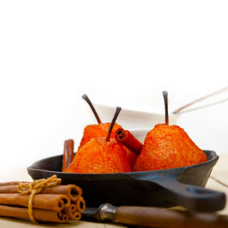 poached pears delicious home made recipe ove white rustic wood tableの写真素材
