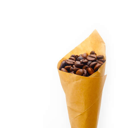 espresso coffee beans on a paper cone cornucopia over white backgroundの写真素材