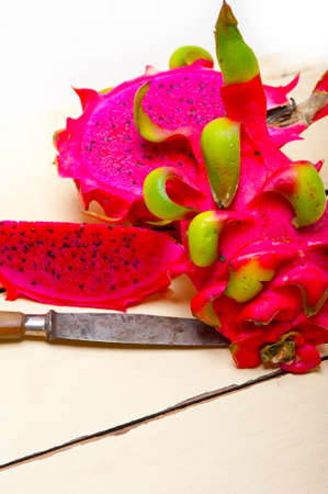 fresh thai purple dragon fruit over white rustic tableの写真素材