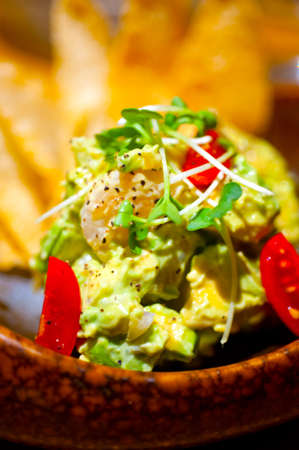 fresh avocado and shrimps salad with nachos on sideの写真素材