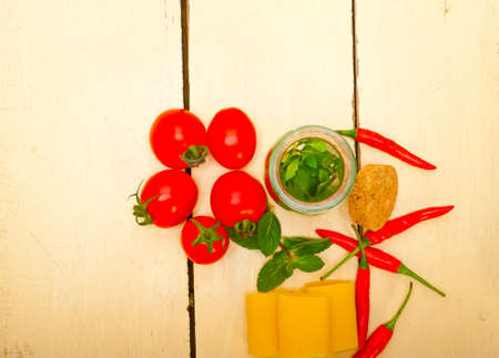 Italian pasta paccheri or schiaffoni with tomato mint and chili pepper ingredientsの写真素材