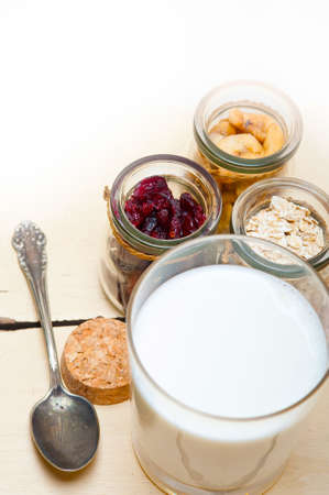 healthy breakfast ingredients milk oat cashew nuts dried cramberry craisinnsの写真素材