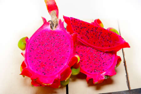 fresh thai purple dragon fruit over white rustic tableの写真素材