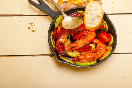 roasted shrimps on cast iron skillet with zucchini and tomatoesの写真素材