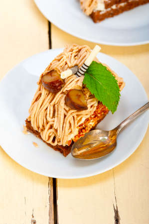 fresh baked chestnut cream cake dessert over rustic white wood table
