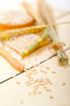 organic barley grains over rustic wood table macro closeupの写真素材