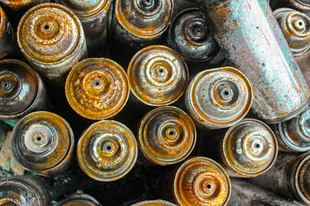 Spray paint cans piled up after a big mural painted.の写真素材