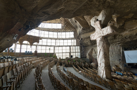 St. Samaan the Tanner Hall with a big cross, part of a huge cave discovered in 1974 in Saint Samaan The Tanner Monastery, and prepared later to contain the hall (accommodating 2000 people for spiritual meetings), and St. Mark's Church. The monastery itselのeditorial素材