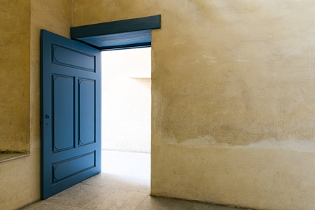 Blue wooden vintage door at an old historic building with plaster wall, Medieval Cairo, Egyptの写真素材