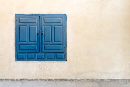 Vintage blue wooden embedded cupboard of a old historic building and vintage plaster wall, Medieval...