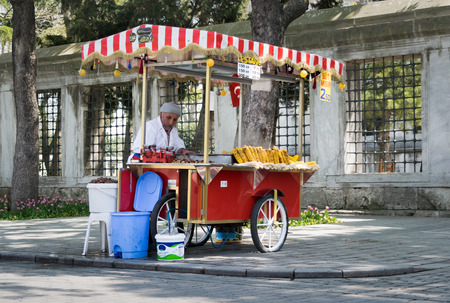 Istanbul, Turkey - April 16, 2017: Old man selling chestnut and corn on traditional Turkish fast food cart in Sultan Ahmed Squareのeditorial素材